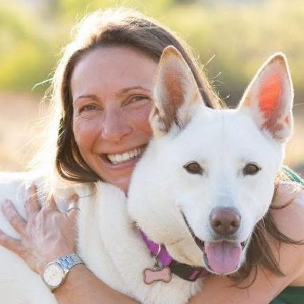 Karina Krepp with her dog in a sunlit field